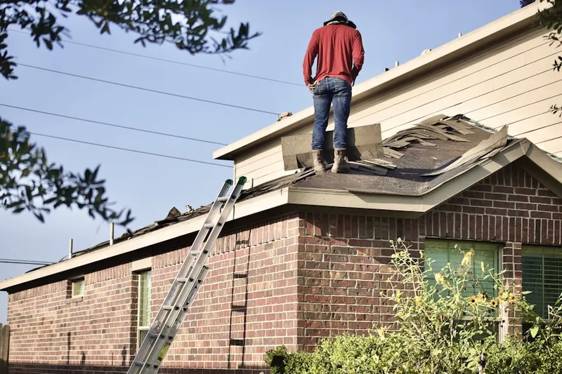 Professional roofer working on a residential roof in Oconomowoc